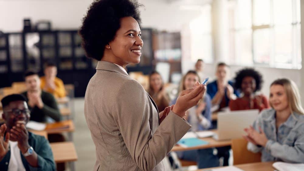 university lecturer using public speaking skills to teach lecture to students